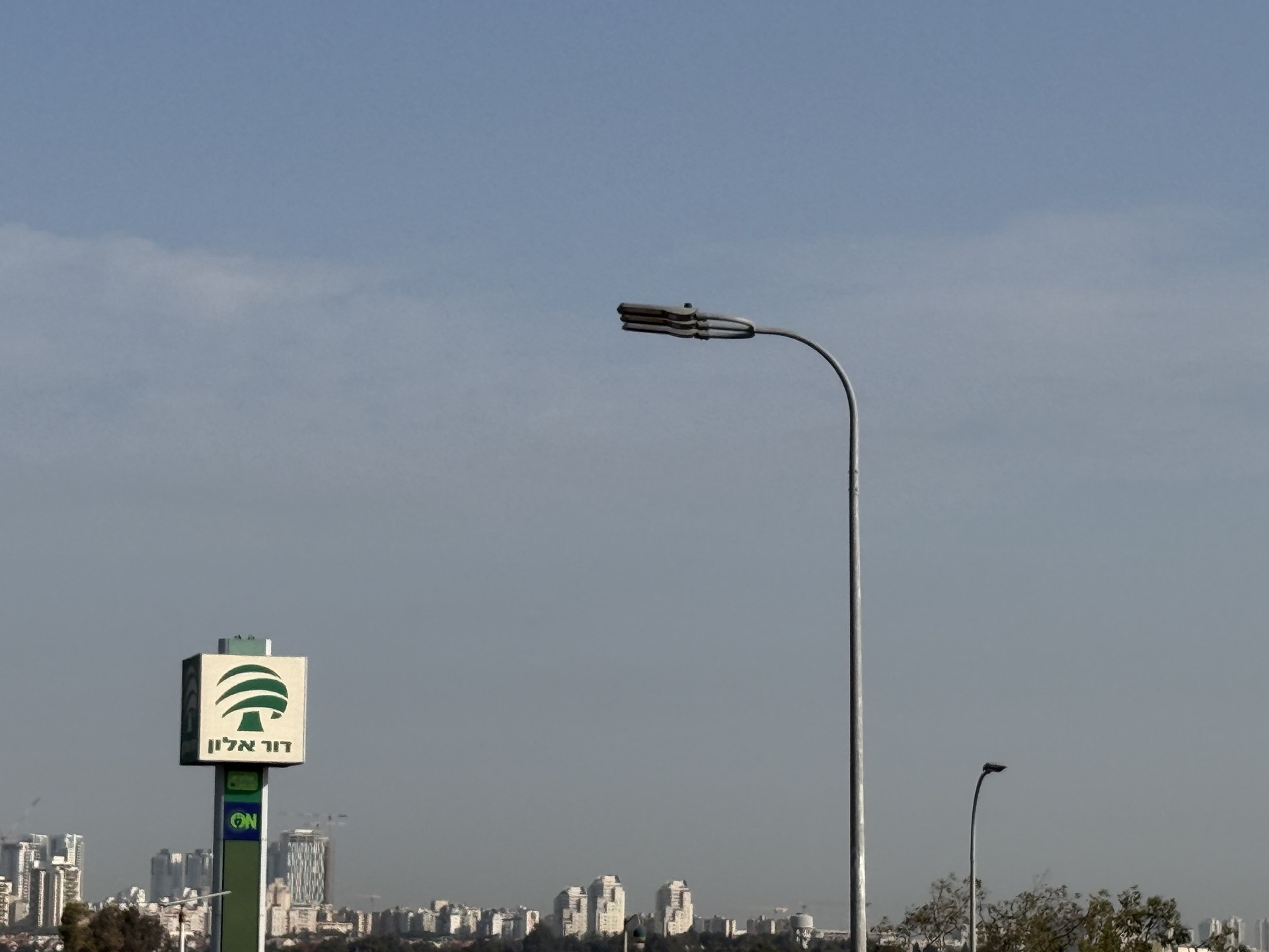 Roadway luminaire installed on a curved arm in a Middle East highway project