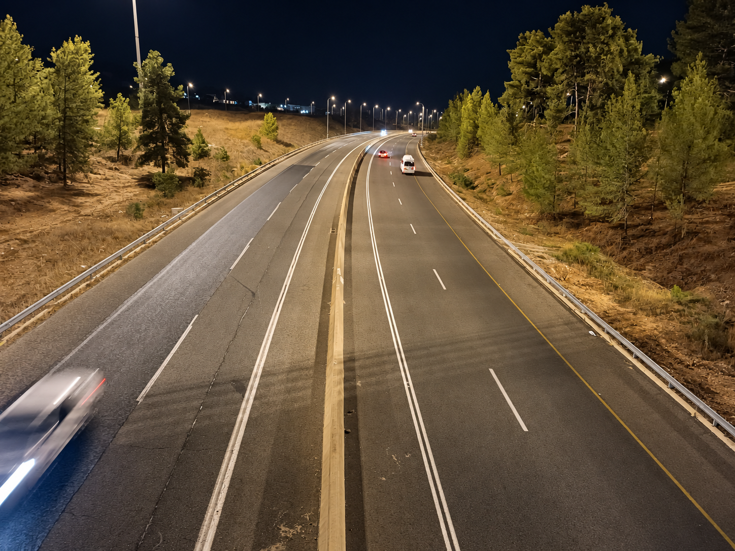 Illuminated divided roadway in a completed outdoor lighting project